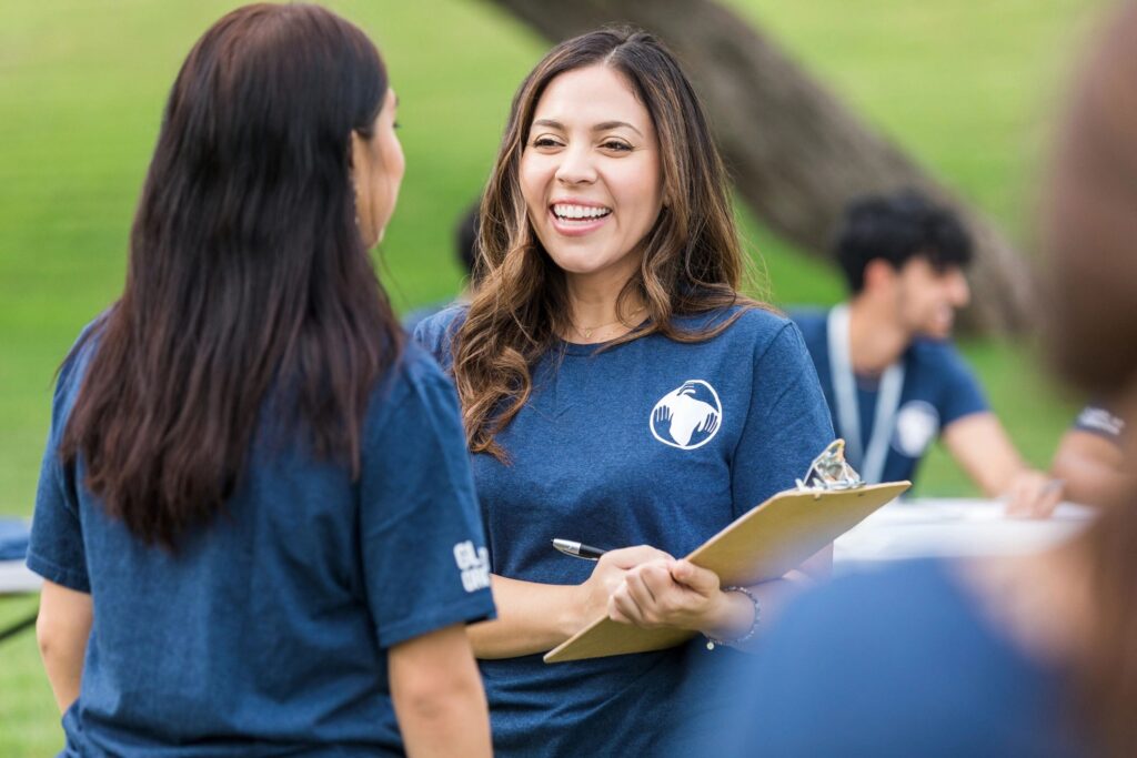 Female friends talk while volunteering at the park